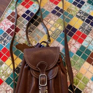 Roots Brown Leather Women's mini backpack bag with Buckle Detail